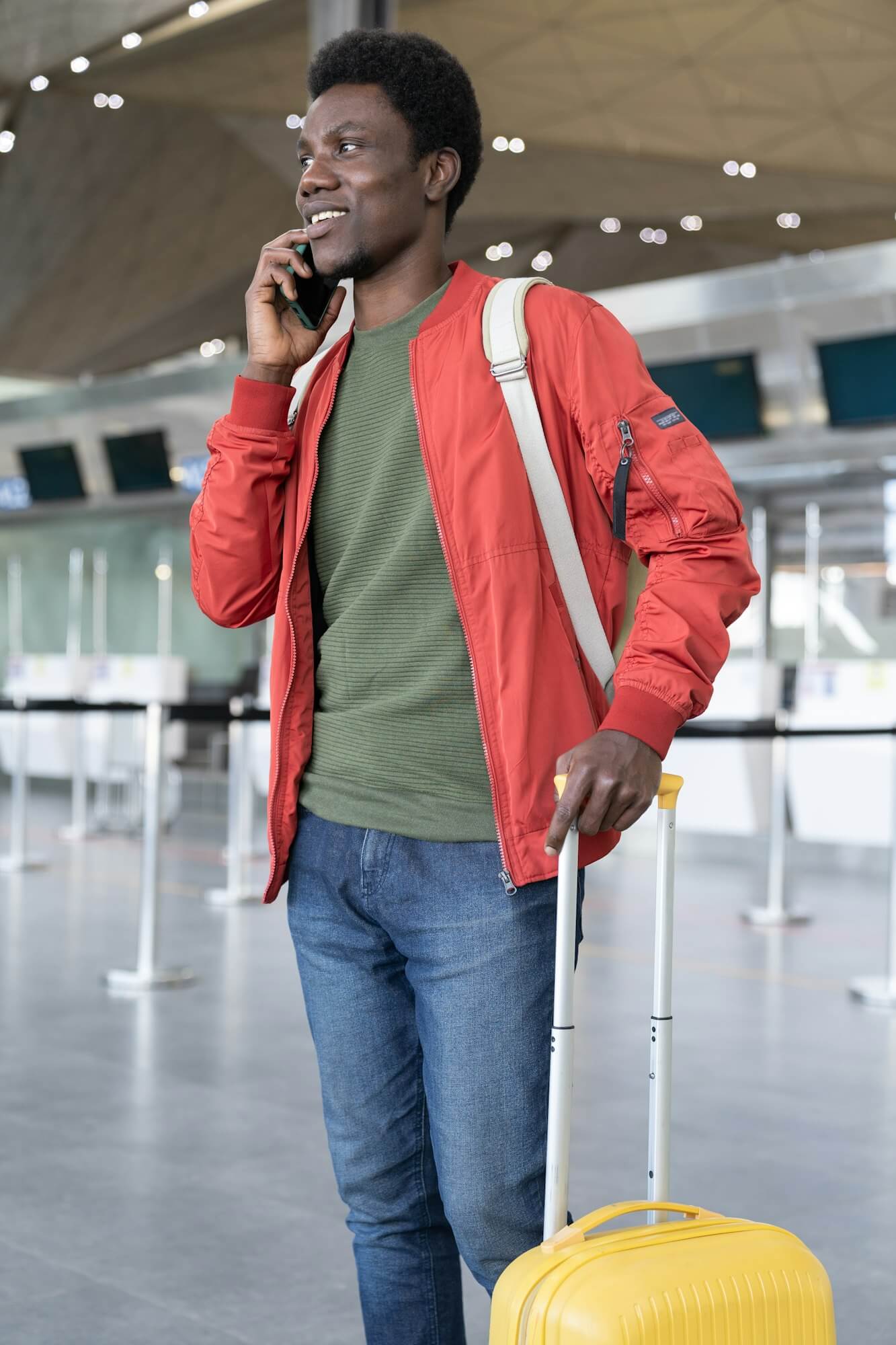 African man talk on phone calling buffalo airport taxi arriving in airport, travel to Canada vacation